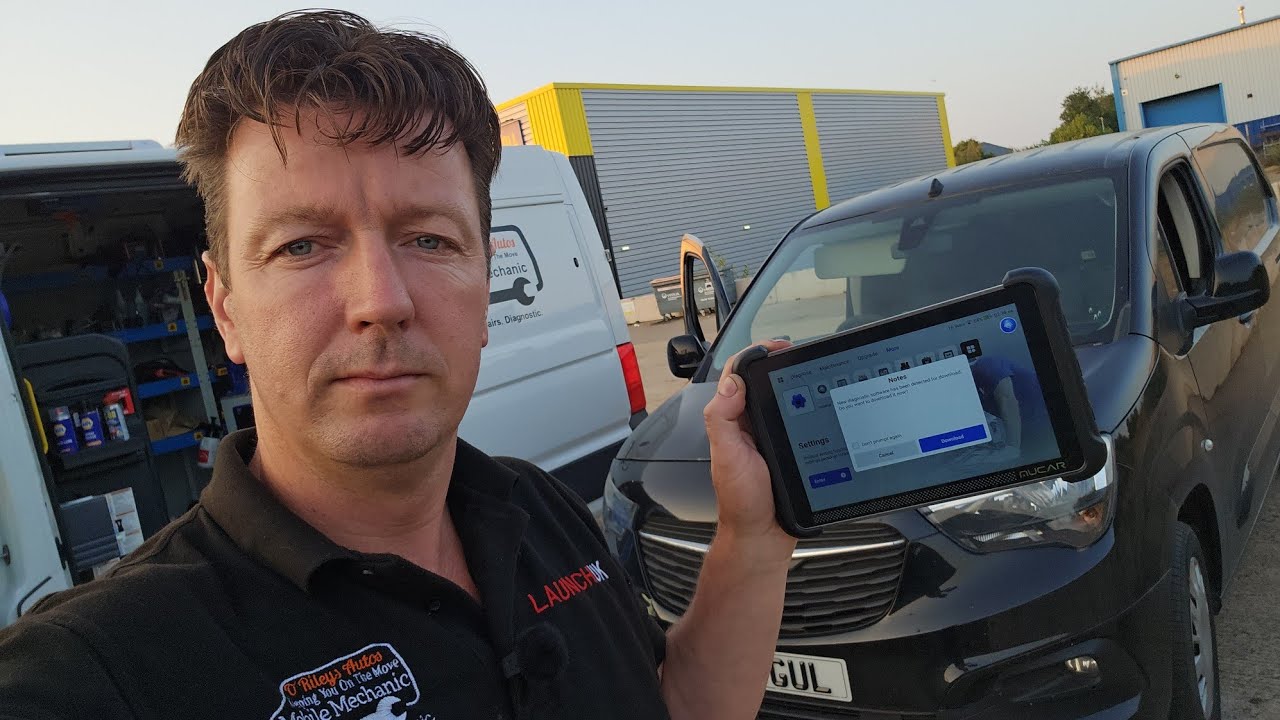 Technician Jimmy O'Riley uses the Mucar 892BT Pro scan tool to diagnose an engine fault on a Vauxhall van in his workshop.