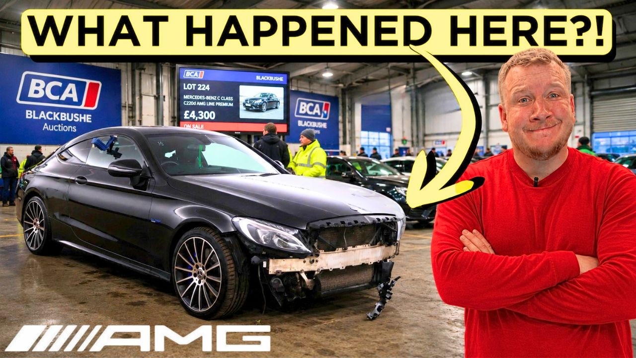 A technician works on the front corner of a damaged Mercedes-Benz C43 AMG in a workshop, diagnosing a headlight fault.