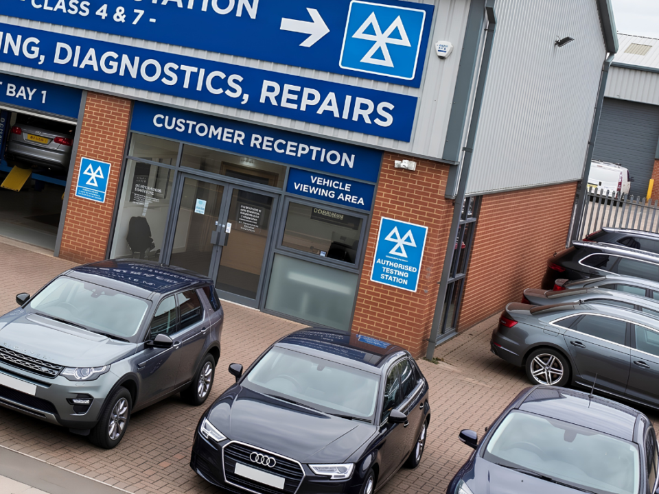 An MOT tester works in a test lane, a setting affected by the debate over frozen MOT test fees.