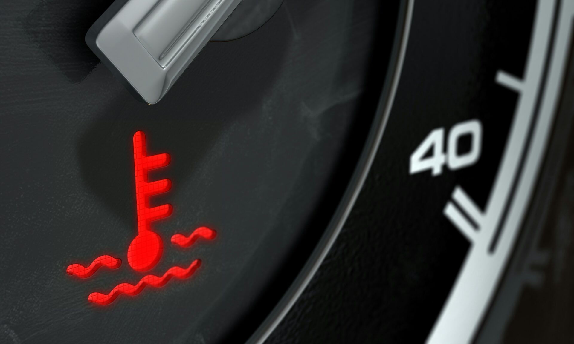 A car's dashboard showing a red overheating warning light, illustrating the diagnostic challenge without an engine
