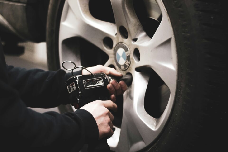 A technician inspects a dangerously worn tyre, a risk some UK motorists are taking due to rising repair costs.