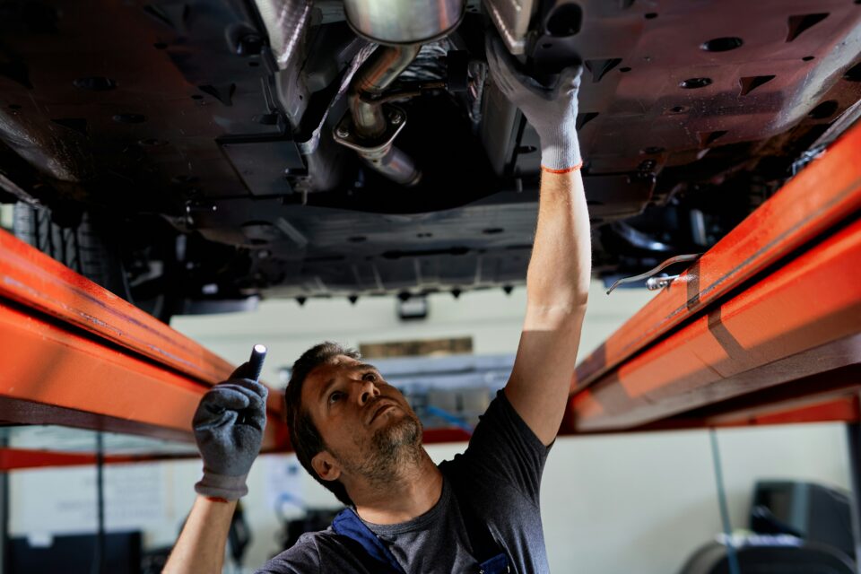 A technician inspects a vehicle during an MOT, a process affected by the debate over MOT fees and fair returns for garages.