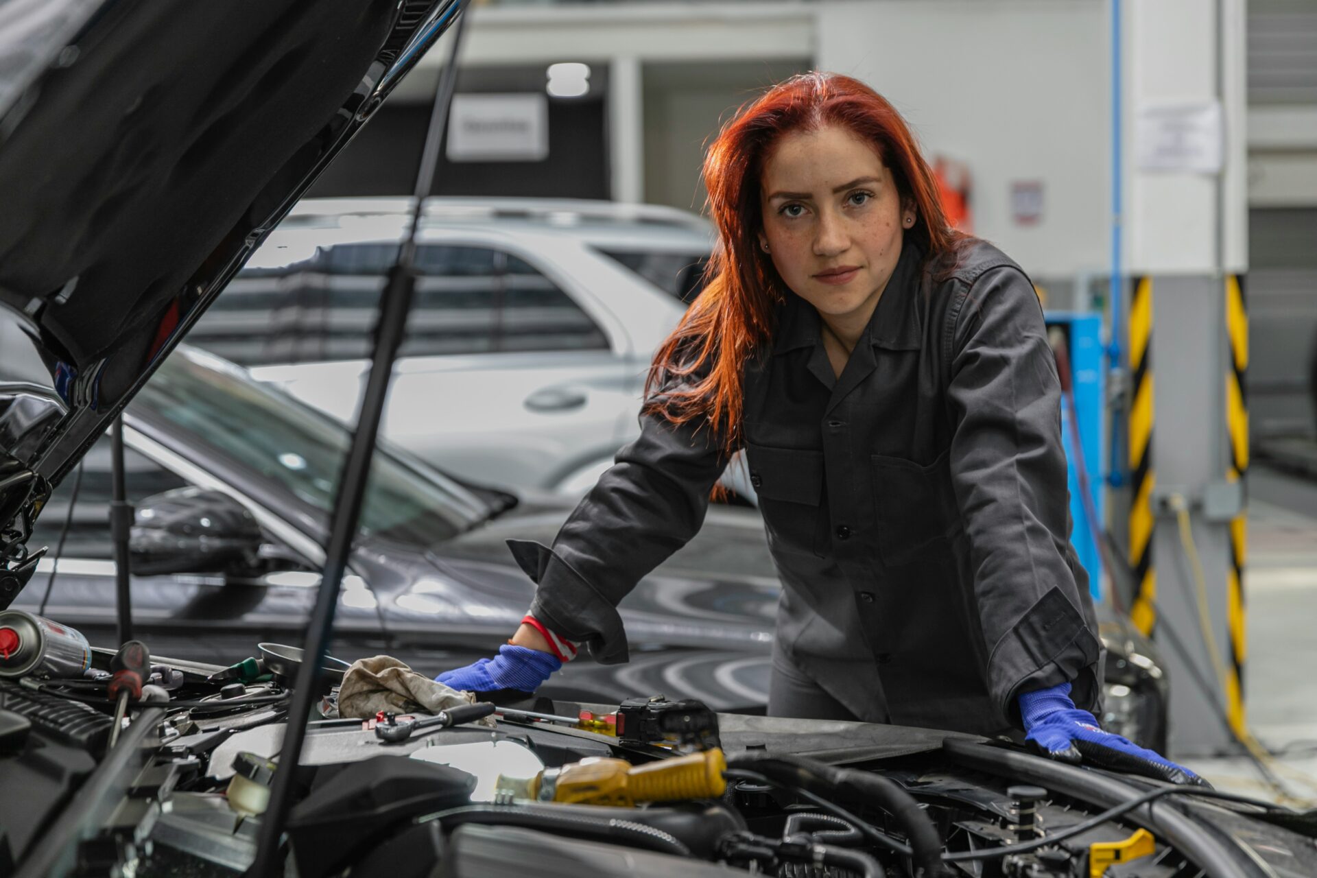A garage owner using a laptop, demonstrating the importance of digital expertise for independent garages in winning