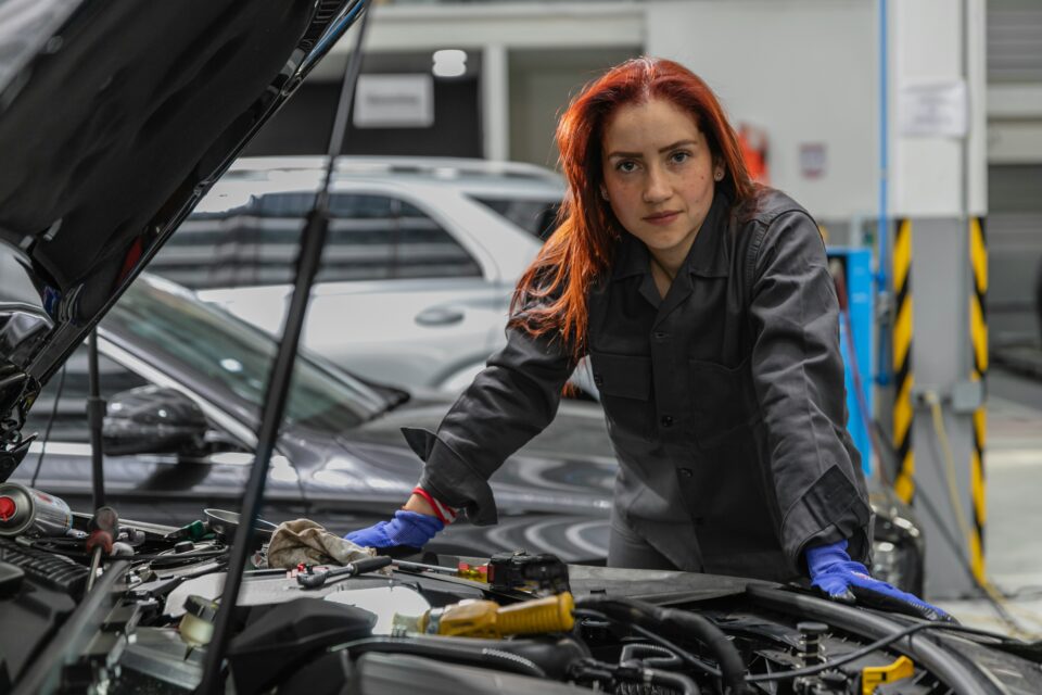 A garage owner using a laptop, demonstrating the importance of digital expertise for independent garages in winning