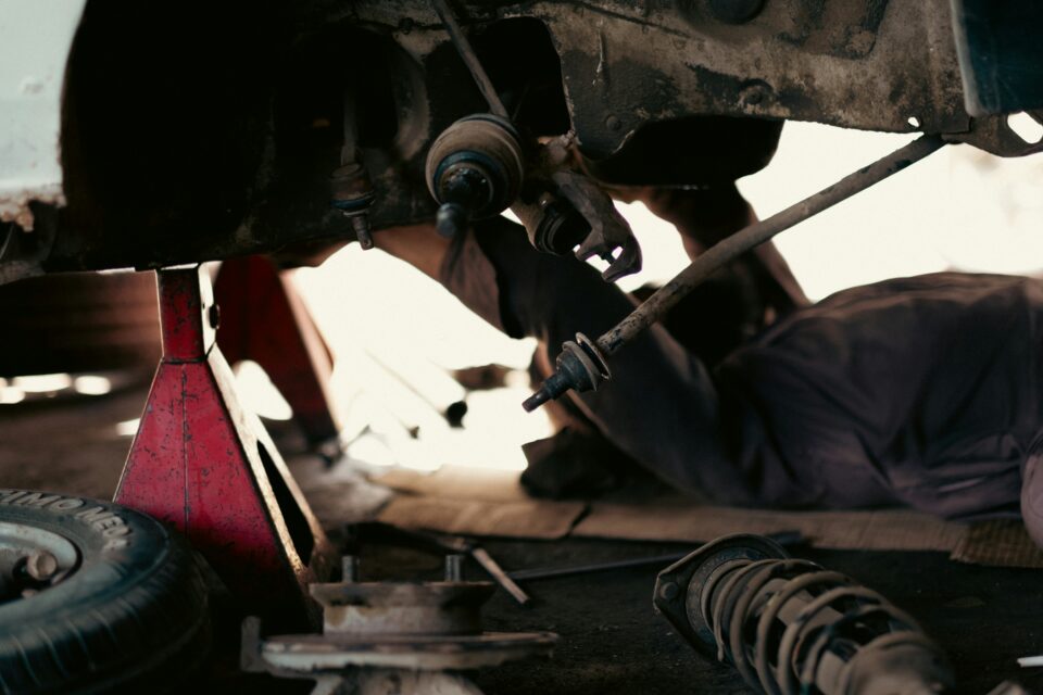 Garage technicians in a workshop discussing the 'Embracing Neurodiversity' training from automotive charity Ben.